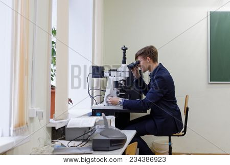 ST. PETERSBURG, RUSSIA - OCTOBER 16, 2017: Schoolchild at microscope in a classroom of the physics and mathematics lyceum 366. This year lyceum celebrates its 70th anniversary