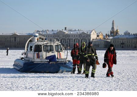 ST. PETERSBURG, RUSSIA - MARCH 4, 2018: EMERCOM staff at their hovercraft during winter swimming competitions Big Neva Cup. Winter swimmers from 12 countries take part in the competitions this year