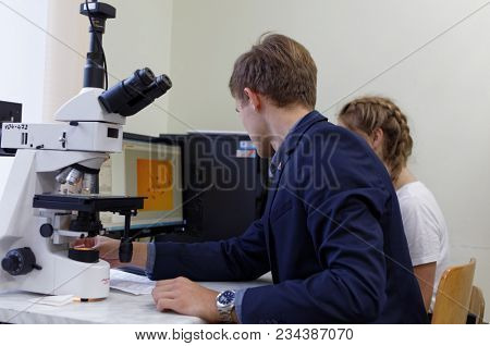 ST. PETERSBURG, RUSSIA - OCTOBER 16, 2017: Schoolchild at microscope in a classroom of the physics and mathematics lyceum 366. This year lyceum celebrates its 70th anniversary