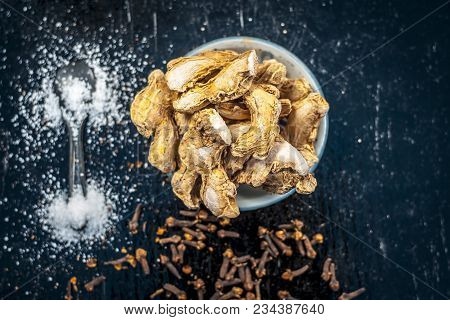 Close Up Of Ayurvedic Herb Or Folk Medicine Dried Ginger Or Zingiber Officinale With Black Pepper Co