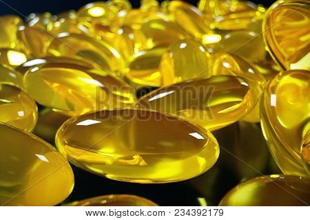 3d Rendering Fish Oil. Omega 3, Omega 6, Omega 9, Vitamin D. Pile Of Capsules Omega 3 On Black Backg