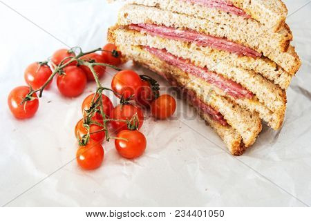 Wholemeal bread sandwich topped with Lyon rosette and butter