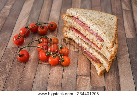 Wholemeal bread sandwich topped with Lyon rosette and butter