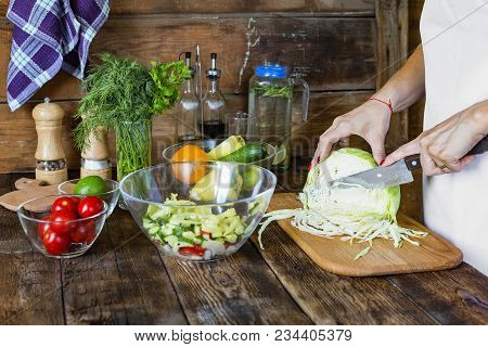Healthy Nutrition. Pleasant Man Holding Knife And Cooking While Cutting Vegetables For Salad