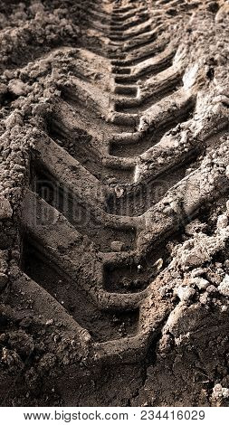 Truck Tire Trails In Mud Dirt During Sunny Day.