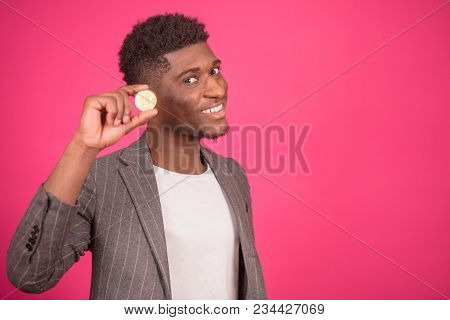 African Magician Is Doing Magic Tricks With Coin. Africam Male Is Keeping Golden Coin. Earn Money.
