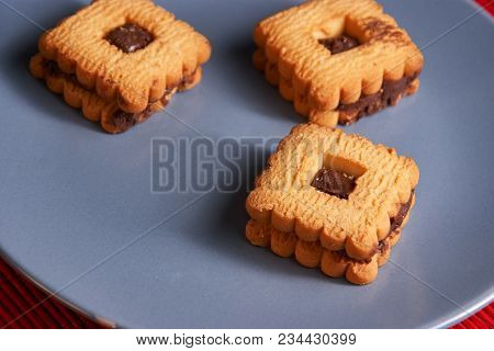 Chocolate Sand Chip Cookies Stacked Up On A Plate, Ready To Be Served.
