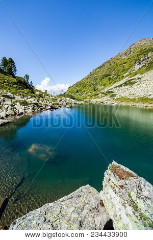 Lake Obersee Between Mountains Rippetegg And Schober And Distant Mountain Range Dachstein In Austria