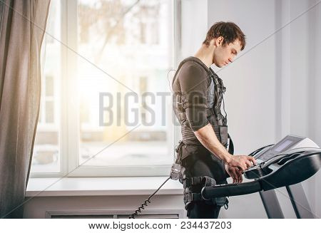 Fit Man In Black Suit For Ems Training Preparing For Running On Treadmill At Gym