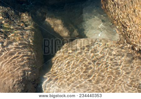 Sunrays Reflecting From Stones And Rocks Underwater - Creating Beautiful Abstract Natural Pattern.  