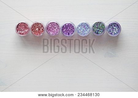 Multi-colored Sequins For The Design Of Nails In A Box. Glitter In Jars. Foil For Nail Service. Phot