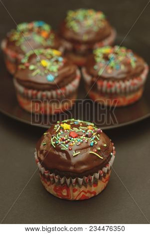 Homebaked Chocolate Muffins For Easter With Colored Conffeti. Dark Background. Sweet Dessert