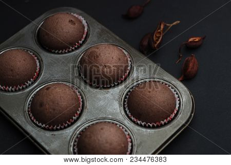 Just Baked Homebaked Chocolate Muffins For Dessert With Colored Conffeti. Black Background.
