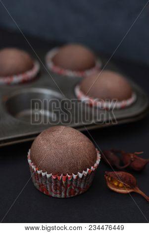 Just Baked Homebaked Chocolate Muffins For Dessert With Colored Conffeti. Black Background.