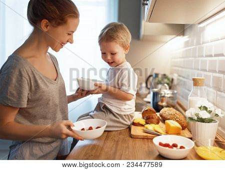 Preparation Of A Family Breakfast. Mother And Baby Son Cook Porridge In Morning