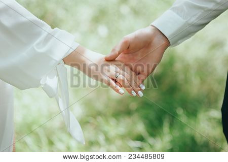 Hand Of Couple Holding Hands In Garden