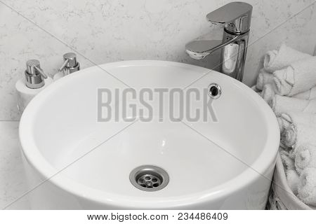 Bathroom Interior With Stylish White Sink. Face Towels Near The Washbasin