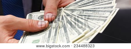 Man In Suit And Tie Hold In Arm Pack Of Hundred Dollar Bills Closeup. Stock Market Exchange Earn Pil