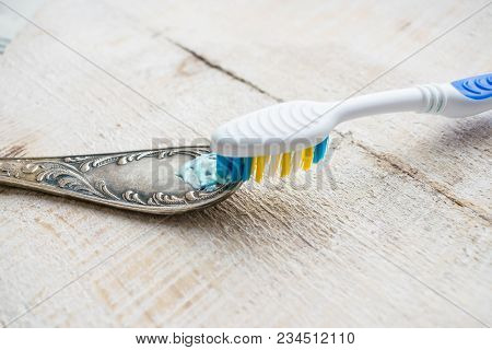 Cleaning The Cutlery With A Brush And Paste. Cleaning Darkened Silverware With Toothpaste Or Cleanin