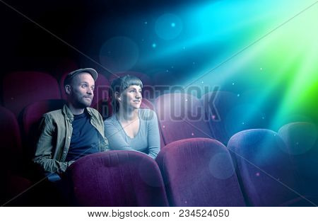 Teenager couple cuddling and watching the climax part of the movie