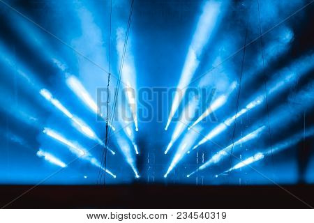 The Light Rays From The Spotlight Through The Smoke. Lighting Equipment On The Ceiling. The Stage Of
