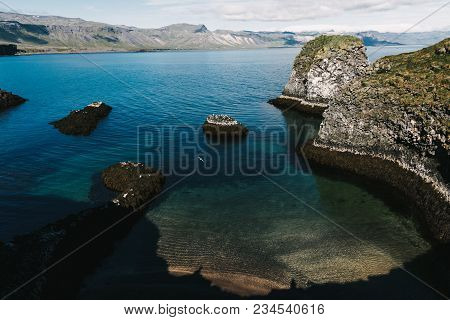 Beautiful Icelandic Landscape With Rocky Coast And Cold Blue Water Of Harbour, Gatklettur, Arnarstap