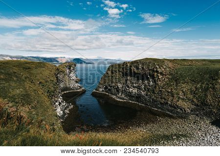 Beautiful Rocky Coast And Cold Blue Water In Gatklettur, Arnarstapi, Iceland