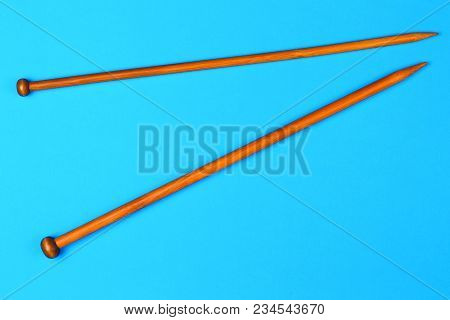 Wooden Knitting Needles On White Background. Top View
