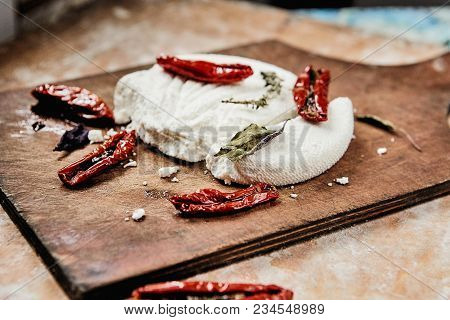 Home Made Goat Curd Cheese With Sundried Tomato And Basil On Dask