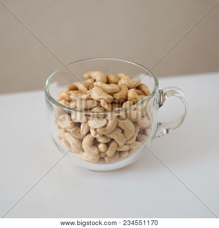 Snacks Of Cashew Snacks Nuts In A Transparent Mug On A White Table
