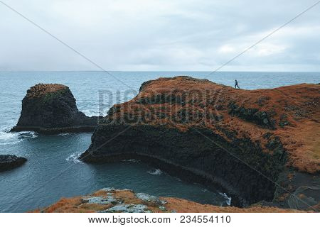 Man Walking On Cliff At Beautiful Ocean, Arnarstapi, Iceland