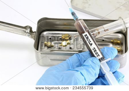 Doctor With Latex Glove Holds A Syringe With The Virulent Blood Infected With The Ebola Virus