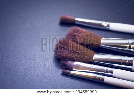 A Set Of Profeccional Make Up Brushes On A Dark Background, Close Up