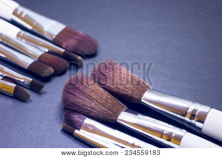 A Set Of Profeccional Make Up Brushes On A Dark Background, Close Up