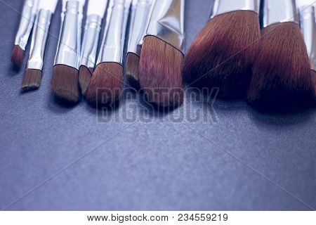 A Set Of Profeccional Make Up Brushes On A Dark Background, Close Up