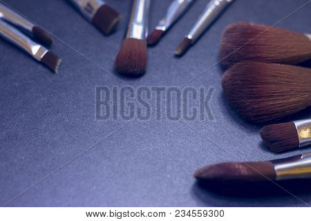 A Set Of Profeccional Make Up Brushes On A Dark Background, Close Up