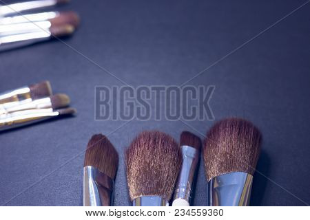 A Set Of Profeccional Make Up Brushes On A Dark Background, Close Up