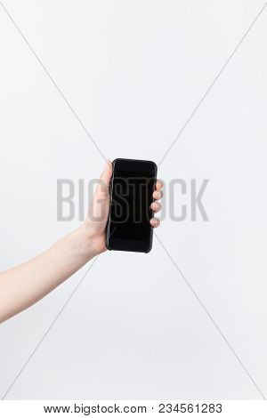 Cropped Shot Of Woman Holding Smartphone With Lank Screen Isolated On White
