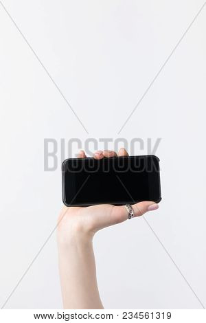Cropped Shot Of Woman Holding Smartphone With Lank Screen Isolated On White