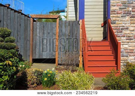 Home Garden Frontyard With Plants Wood Fence Gate Colorful Staircase Sidings And Stone Wall