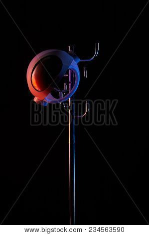 Astronaut Helmet On Coat Rack Under Toned Light Isolated On Black