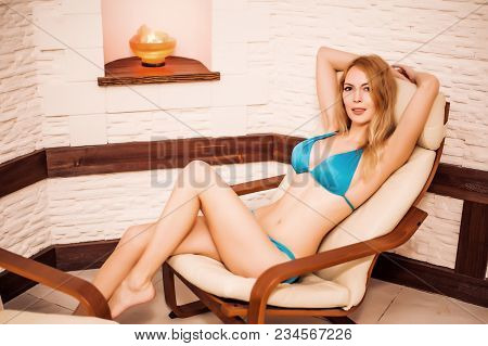 Beautiful Girl Sit On Chair In Spa In Salt Room