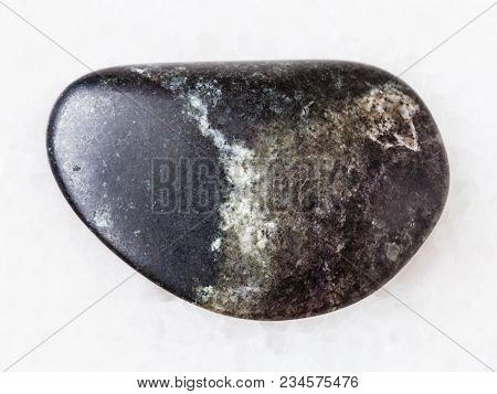 Macro Shooting Of Natural Mineral Rock Specimen - Tumbled Olivinite Stone On White Marble Background