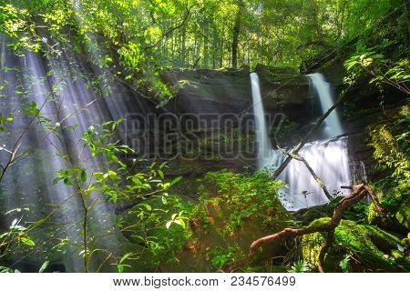 Mun Dang Waterfall With A Pink Flower Foreground In Rain Forest At Phitsanulok Province, Thailand