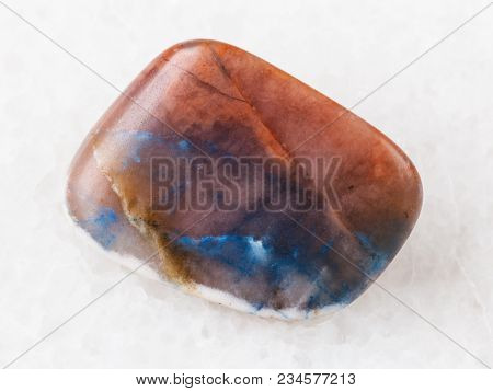 Macro Shooting Of Natural Mineral Rock Specimen - Tumbled Irnimite Gemstone On White Marble Backgrou