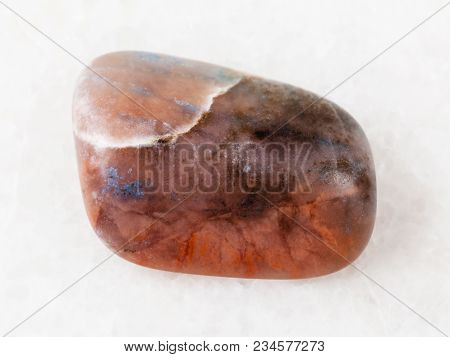 Macro Shooting Of Natural Mineral Rock Specimen - Polished Irnimite Gemstone On White Marble Backgro