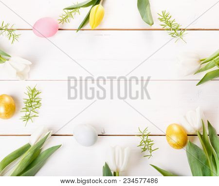 Easter Spring Background With Easter Blue, Pink And Gold Eggs, White And Yellow Tulip On White Woode