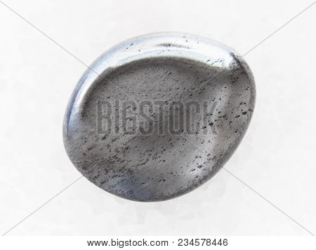 Macro Shooting Of Natural Mineral Rock Specimen - Polished Hematite Gemstone On White Marble Backgro