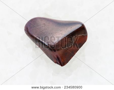Macro Shooting Of Natural Mineral Rock Specimen - Tumbled Jaspilite Jasper Gemstone On White Marble 