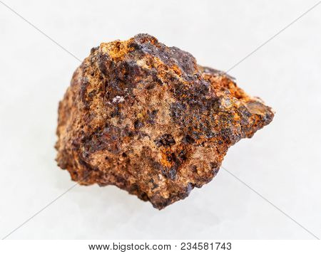 Macro Shooting Of Natural Mineral Rock Specimen - Raw Hematite (iron Ore) Stone On White Marble Back